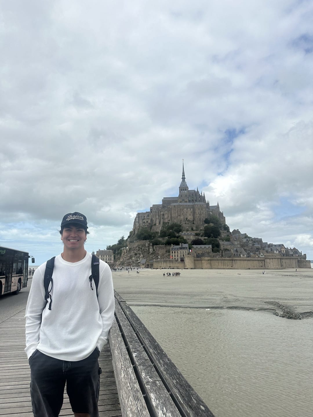 Caleb smiling on the causeway in front of Mont-Saint-Michel